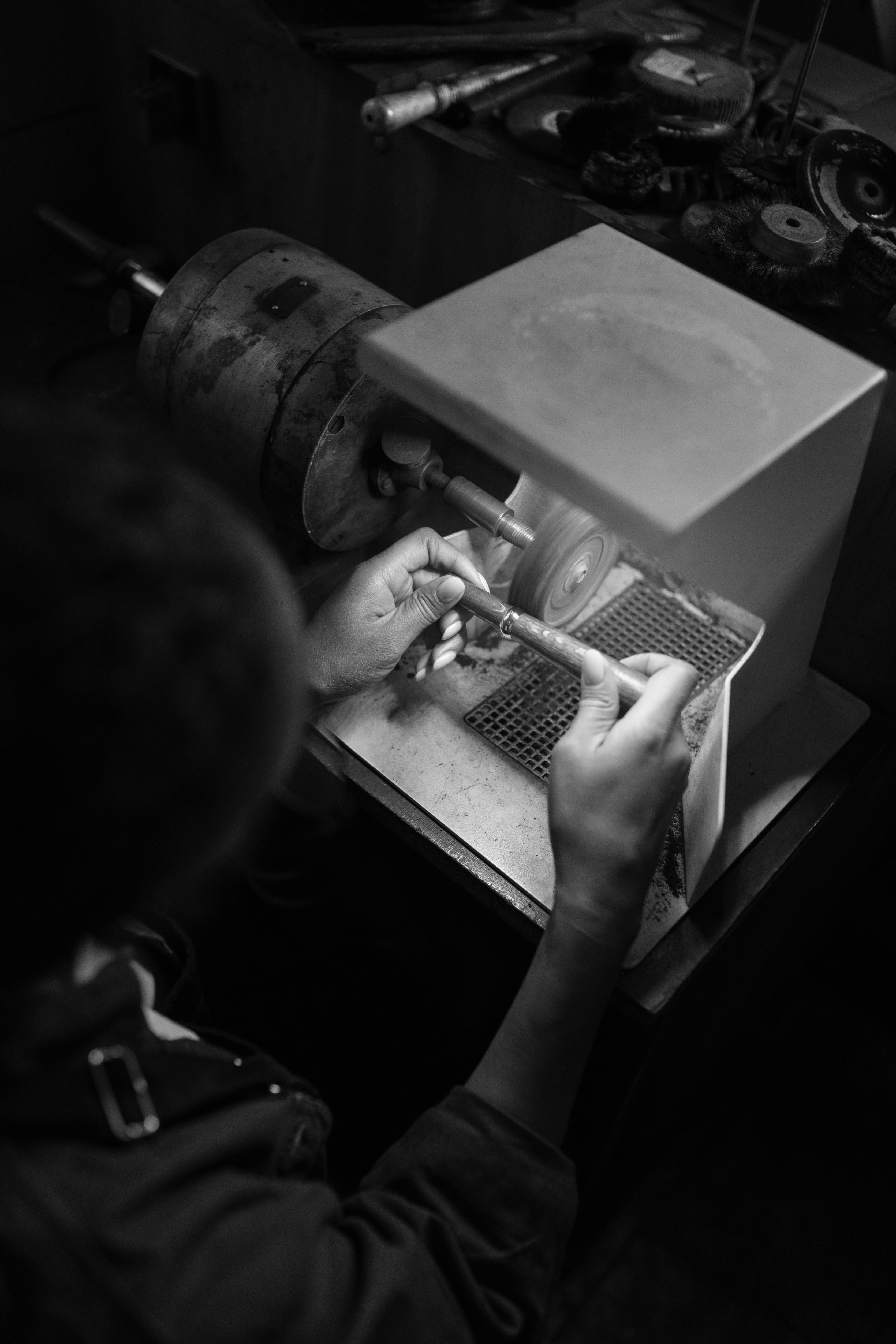 a jeweller crafting a ring with a machine