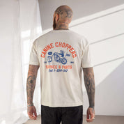 Man wearing a 'Canine Choppers' t-shirt with a motorcycle graphic on the back.