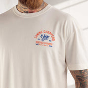 Beige t-shirt with 'Canine Choppers' graphic design on a plain background