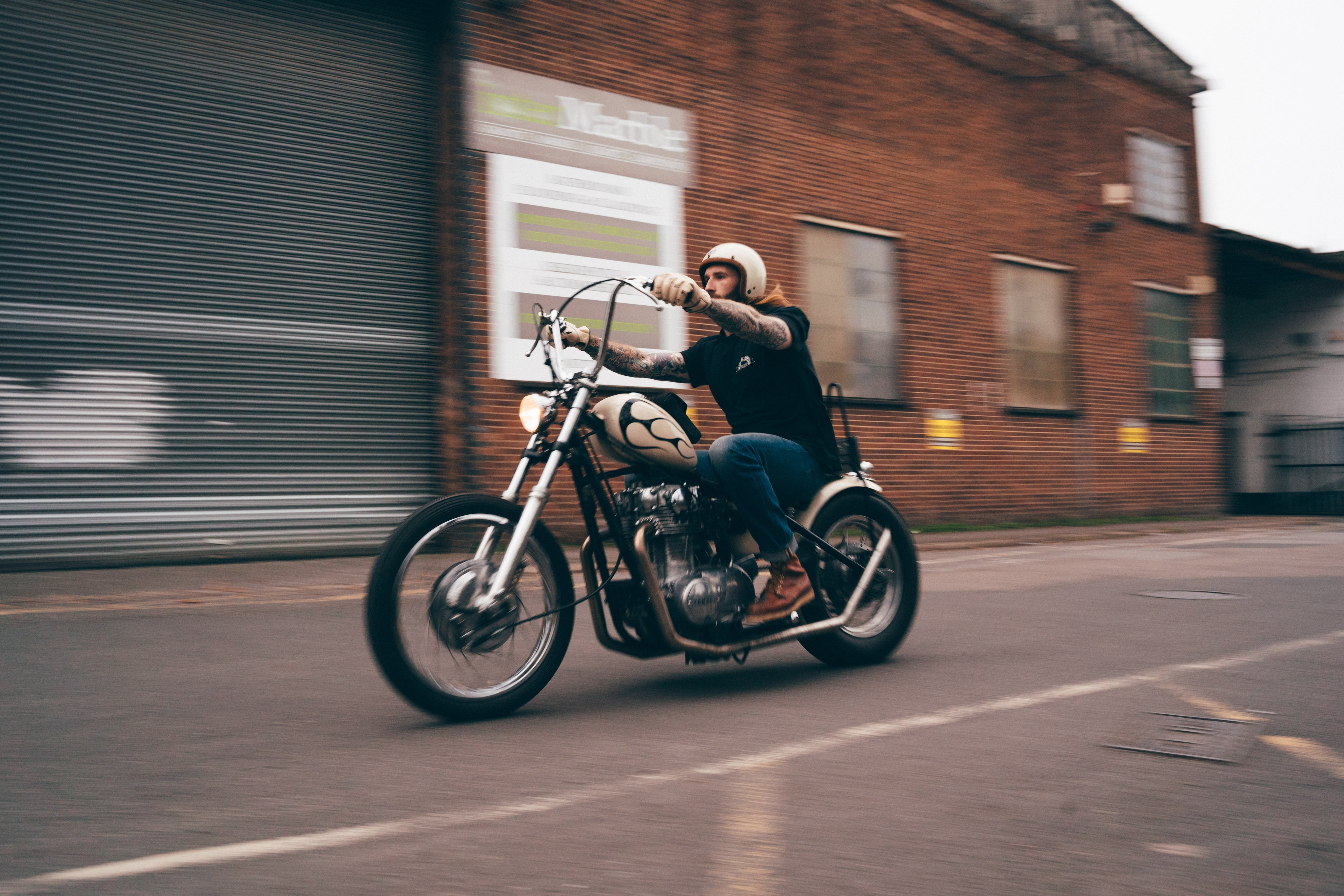 Person riding a motorcycle on a street with a blurred background