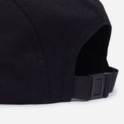 Close-up of a black cap with a strap on a white background