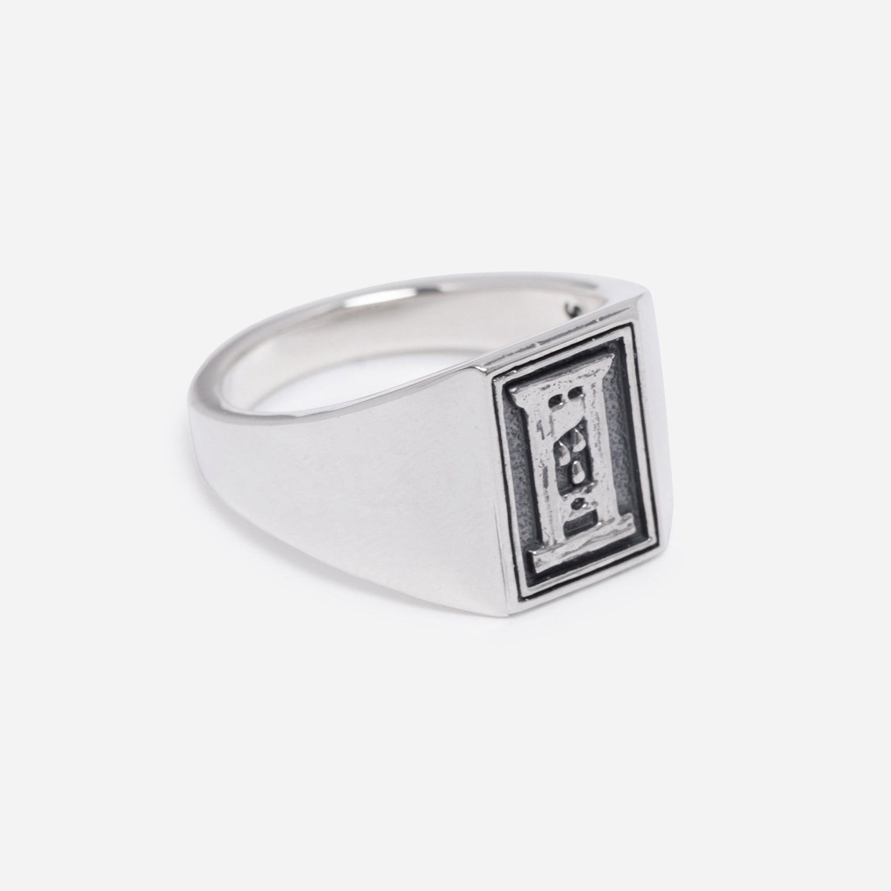 Silver ring with a black and white design on a white background